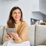 Air Conditioning, Heating & Plumbing Services in Lancaster, CA 3 Smiling woman holding a tablet